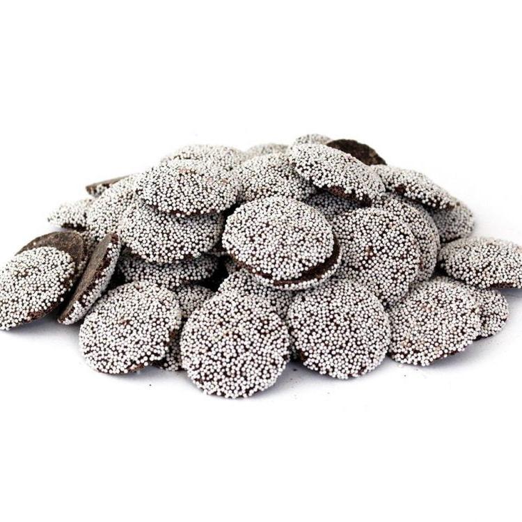A pile of dark chocolate nonpareils on a clean white background