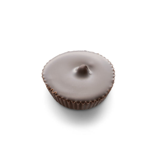 A dark chocolate cup of peanut butter covered in dark chocolate with a white background