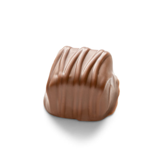 A cube-shaped piece of caramel coated in milk chocolate