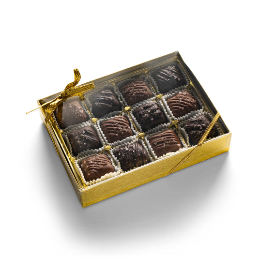 A gold gift box with 12 milk chocolate and dark chocolate sea salt caramels