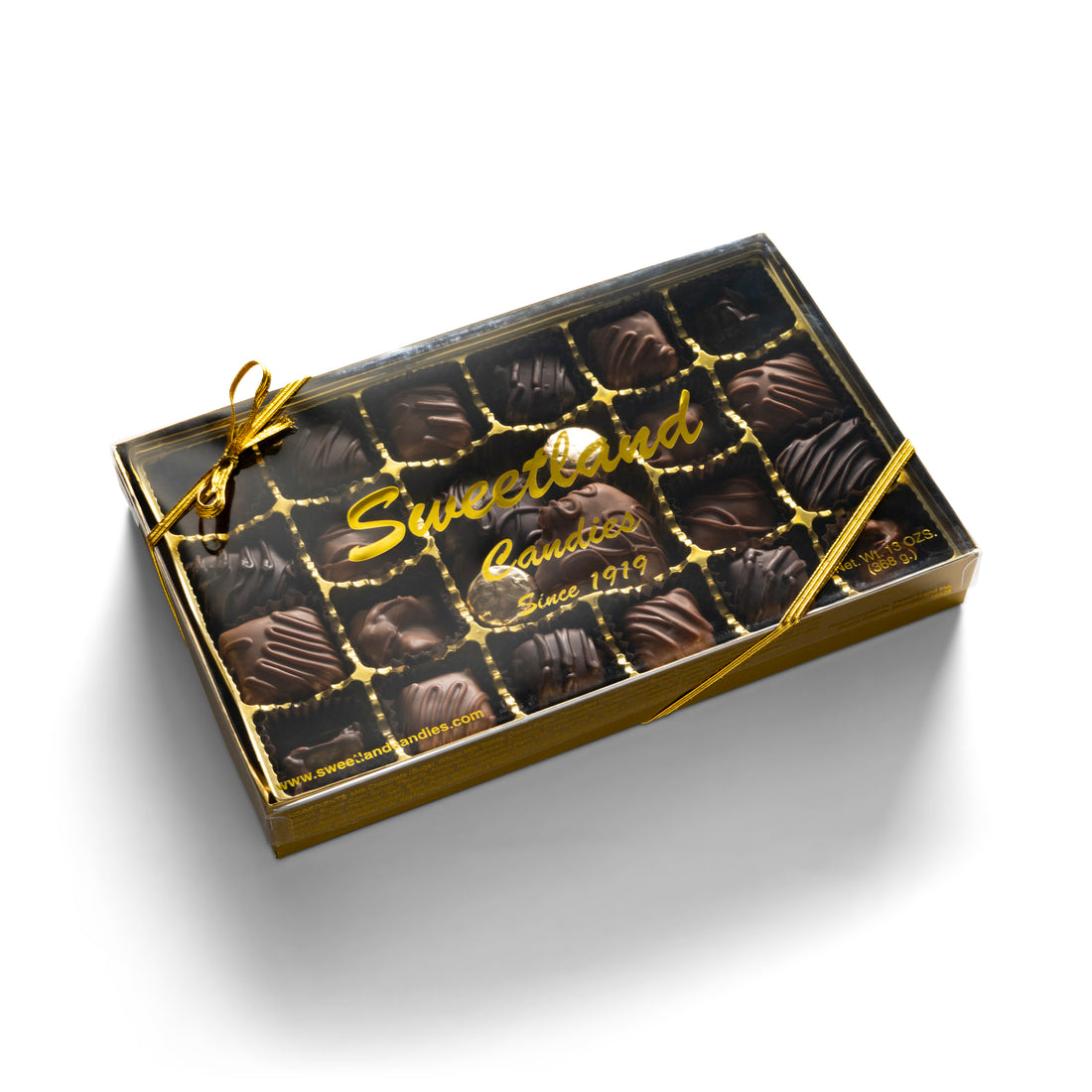 An elegant box of assorted chocolates, topped with a shimmering gold ribbon, perfect for gifting or indulgence.