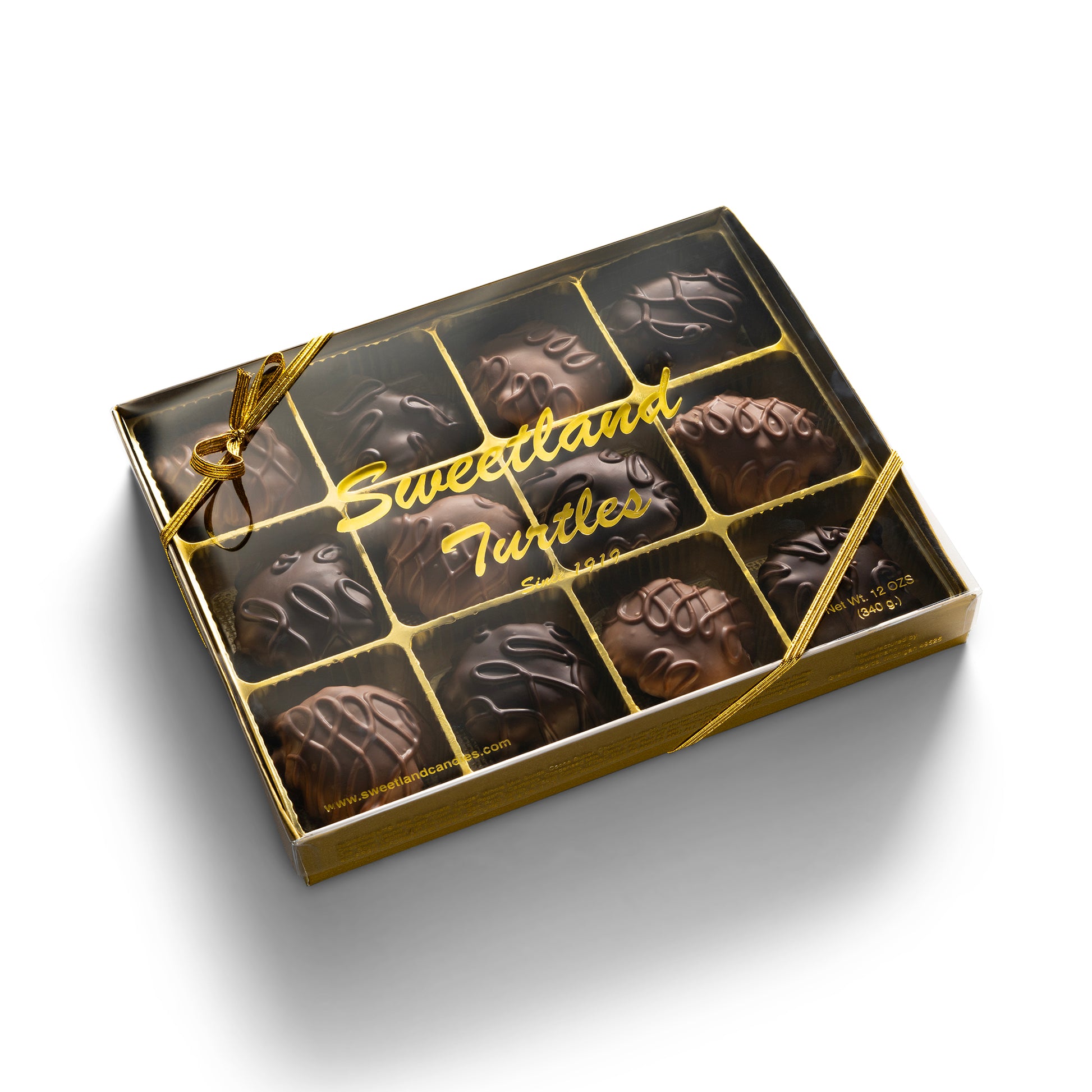 A gold gift box with 12 dark and milk chocolate turtle candies