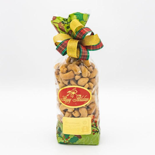 An attractive gift bag filled with roasted salted colossal cashews, featuring a decorative ribbon, ideal for nut lovers
