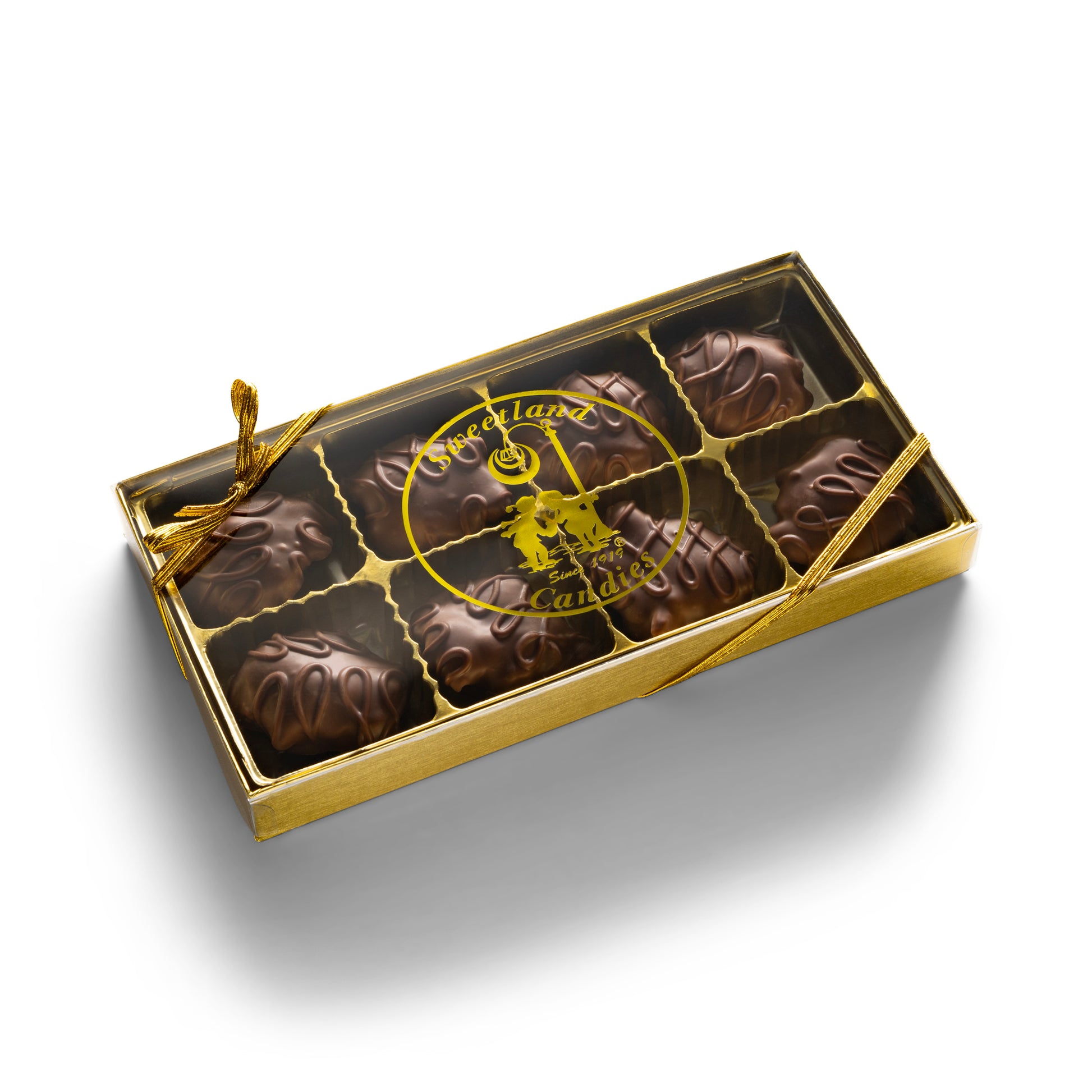 A gold gift box with 8 milk chocolate turtle candies