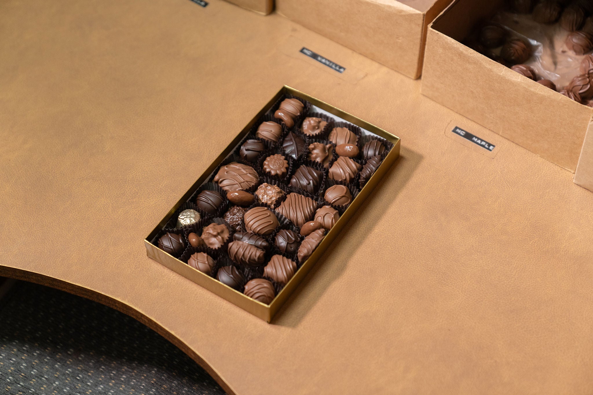 Box of chocolates on a brown surface