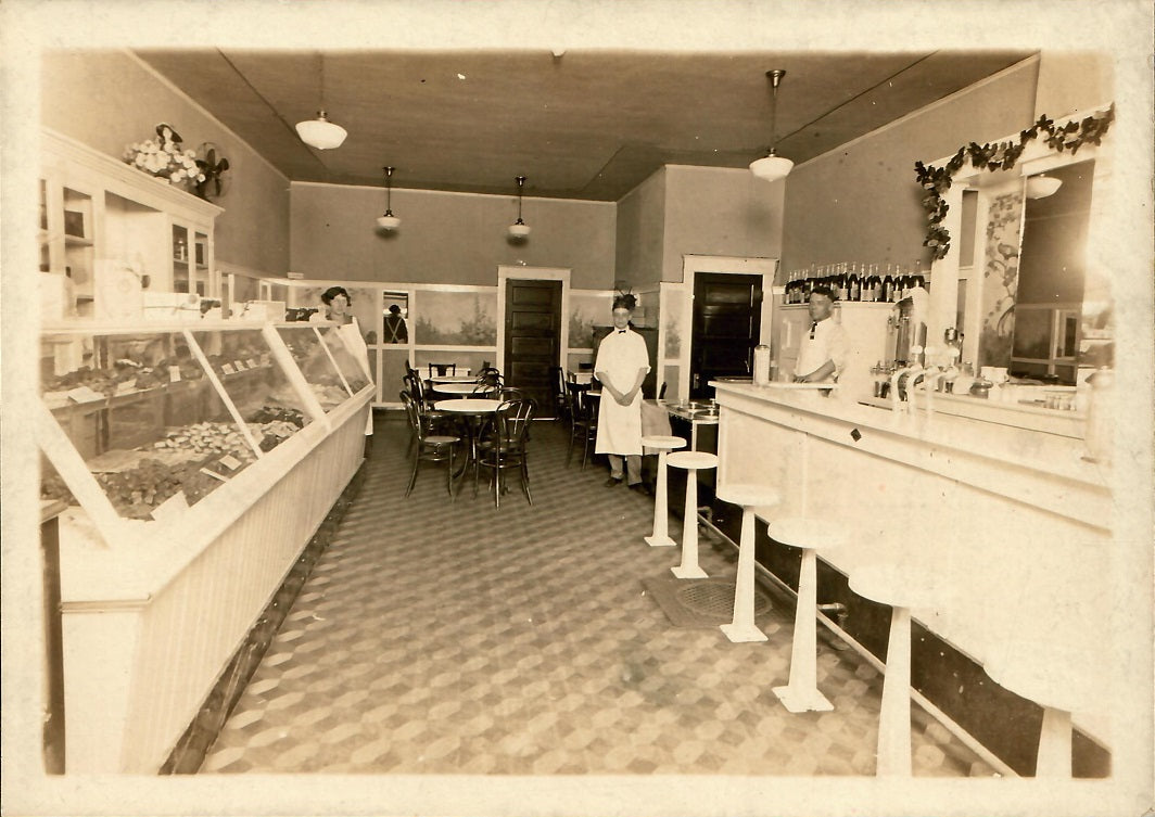 Historic photo of old Sweetland Candies store in Michigan showing candy cases and barstools